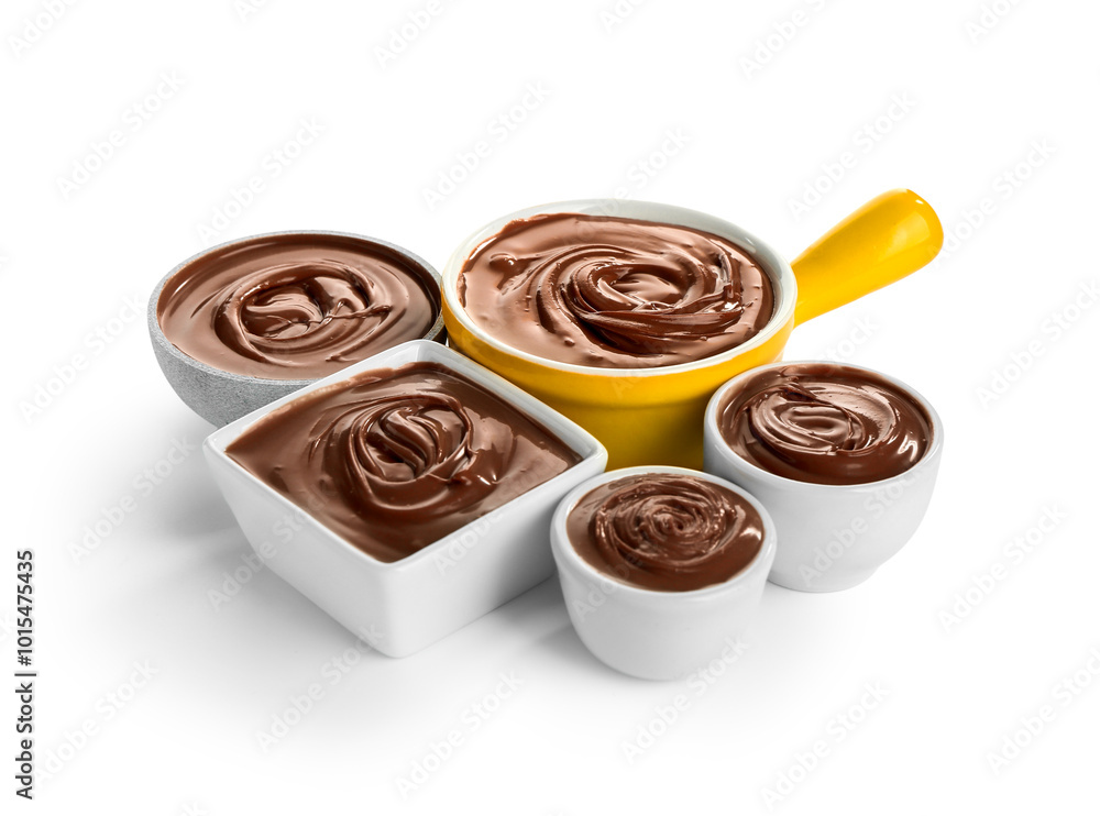 Bowls of tasty melted chocolate on white background
