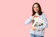 © Pixel-Shot - Young woman with magazines on pink background