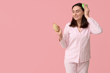 Sticker - Beautiful young woman with hair scalp massager and body brush on pink background