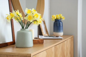 Canvas Print - Chest of drawers, mirror and vases with narcissus flowers in room