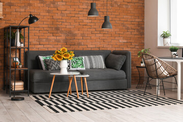 Sticker - Cozy sofa, coffee table with sunflowers and workplace in interior of living room