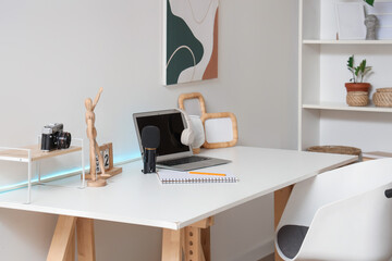 Poster - Podcaster's workplace with laptop in light studio