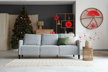 Poster - Interior of living room with sofa, fir tree and decor for Japanese New Year celebration