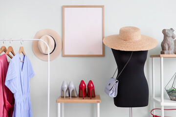 Poster - Interior of dressing room with mannequin, shelf units and blank frame