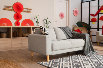 Sticker - Interior of living room decorated for Japanese New Year celebration with sofa and shelf unit