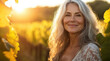© kora studio - older middle age woman with blonde silver  hair is walking in her vineyard in Napa Valley  looking after her grapes and enjoy the fresh air
