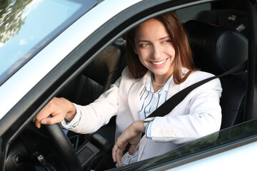 Wall Mural - Woman holding steering wheel while driving car