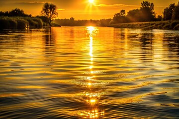 Golden light reflecting on river at sunset, creating a shimmering effect