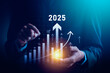 © Sutthiphong - Businessman Analyzing 2025 Growth Trends with Digital Bar Graphs and Arrows Highlighting Financial Success, Strategic Planning, and Market Predictions for Future Business Growth and Profitability