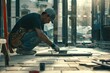 © NikoG - Craftsman precisely installing floor tiles at a construction site