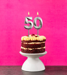 Poster - Birthday cake with number 50 candle - Red velvet on a fuchsia background.