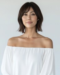 Confident Asian Female Professional in White Off-Shoulder Attire — Modern Business Portrait