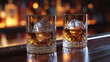 © LOPH Studio - Two crystal glasses of whiskey with ice on wooden bar