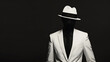 © wanchai - A person wearing a white suit with a black tie and hat. The face is not visible, set against a dark background with high contrast, resulting in a monochrome image.