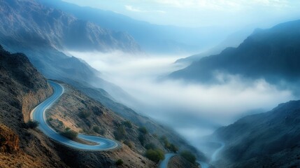 A mountain road snaking its way through a valley, gradually disappearing into the sea of fog below.