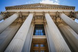 Fototapeta Panele - A majestic building features towering pillars and an impressive entrance, symbolizing justice and power.