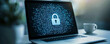 © Achirawee - A laptop computer on a desk with a digital padlock icon displayed on the screen, symbolizing cyber security, set against the backdrop of a modern office environment, with copy space for text or
