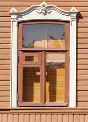 Wall Mural - A window with a brown frame and white trim