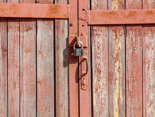 Wall Mural - A rusty lock on a wooden door