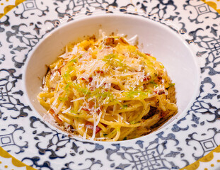 Close-up of delicious pasta carbonara dish served on elegant plate