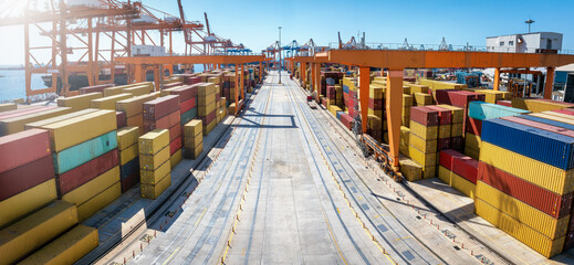 Elevated view of rows of stapled cargo containers in a commercial freight harbour terminal