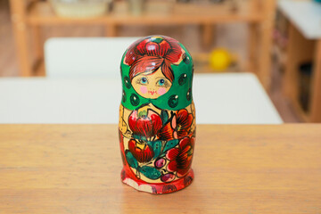 Vibrant hand-painted Russian nesting doll displayed on wooden table