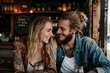 © Asier - Beautiful young couple in love sitting in a pub and smiling.