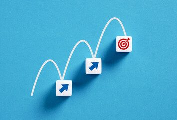 Wall Mural - arrow signs leading to target on blue background, business concept