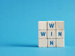 © Cagkan - Win win situation concept with wooden cubes on blue background