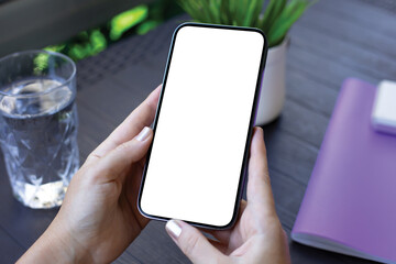 female hands holding phone with isolated screen background table cafe