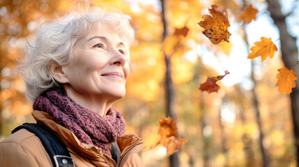 Elderly woman smiling in an autumn park, surrounded by falling leaves and vibrant orange foliage while enjoying nature's beauty