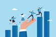 © Nuthawut - Growth assistance, support or help to success, growing business, career path or leadership helping employee achievement, manager support concept, businessman hand help people climb growth graph.