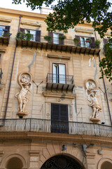 Palermo, Sicily, Italy. Facade of an ancient house with sculptures and balconies on Via Lungarini. Sunny summer day