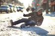 © Juri - A man falls on a dangerous section of icy sidewalk.