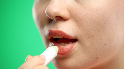 Woman's mouth, close-up, on a green background