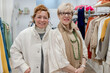© ADDICTIVE STOCK - Two senior women smiling together in a clothing store
