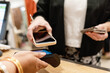 © ADDICTIVE STOCK - Customer Using Mobile Phone for Contactless Payment at Store