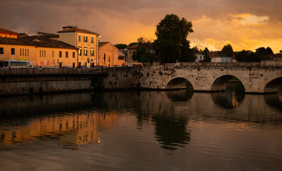 Discover the iconic Ponte di Tiberio, a Roman bridge spanning the River Marecchia in Rimini, Italy. Built in 20 AD, this majestic structure is a testament to Roman engineering and a must-see