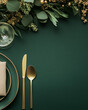 © TiA - Elegant table setting with gold cutlery on dark green background