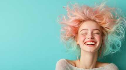 Wall Mural - An excited woman with distinct pink hair beams with a wide smile in front of a striking turquoise background, capturing an energetic moment full of happiness and youth.