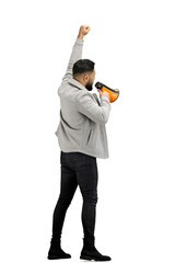 A man, full-length, on a white background, with a megaphone