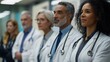 © Oulaphone - A diverse group of medical professionals in white coats, standing confidently, representing teamwork and dedication in healthcare.