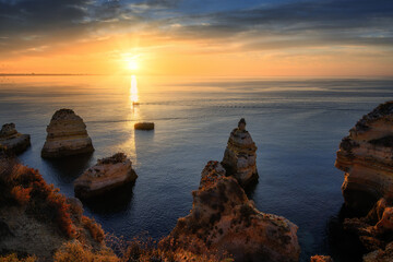 sunrise at Praia da Balanca with rocks and sun