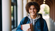 © Galeno - portrait smiling college student curly hair wearing backpack holding books ready academic success