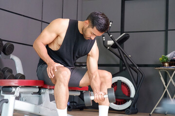 Young man exercising in a fitness gym. Health and fitness.