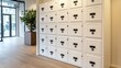 © lililia - A row of white lockers with sleek black handles is set against a blurred background, highlighting a contemporary office space designed with minimalism and simplicity