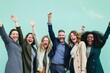 © Iigo - Diverse group of women and men celebrating success over blue background.