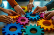 © Edgar Martirosyan - A group of people holding colorful gears in their hands, a collaboration and success concept.