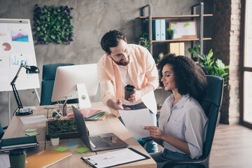 Wall Mural - Photo of professional man lady discuss papers working together colleagues coworking successful businesspeople nice light office