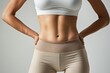 © Olga - A woman with a white tank top and gray pants is posing for a photo